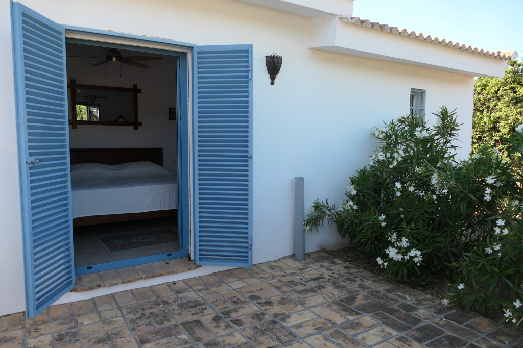 Bedroom with sky-blue shutters
